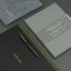 Two notebooks and a pen on a dark surface with 'The Executive Notebook'