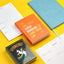 Colorful books and planners on a yellow background