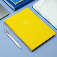 Prompt Journal yellow on a blue surface