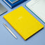 Prompt Journal yellow on a blue surface