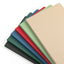 Set of colorful cutting boards stacked on a white background