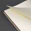 Open notebook with lined pages on a dark gray background
