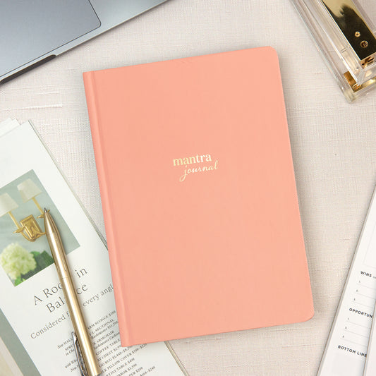 Pink Mantra Journal on a desk